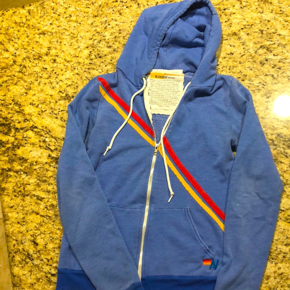 Lt blue red /yellow striping. Distressed super soft. SizeLarge more like medium.